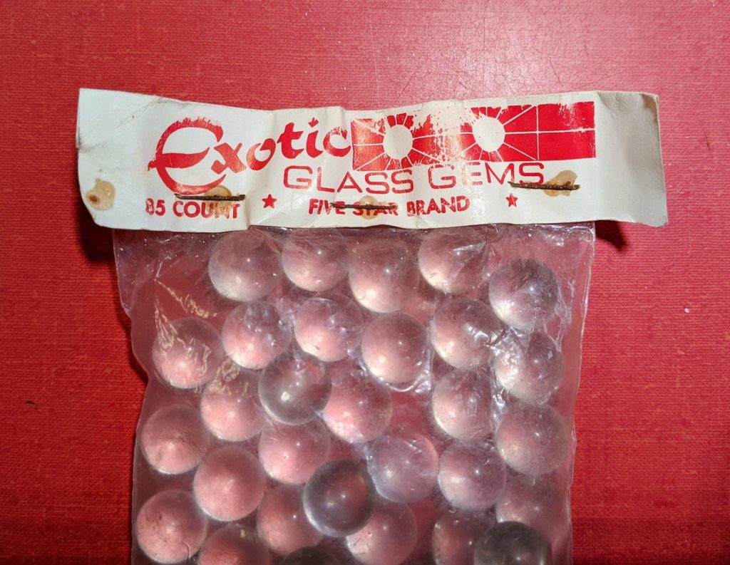 Vintage clear marbles in original packaging. 11 ounces